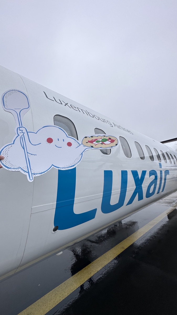 Jean-Cloud beside a Luxair plane before the trip to Naples